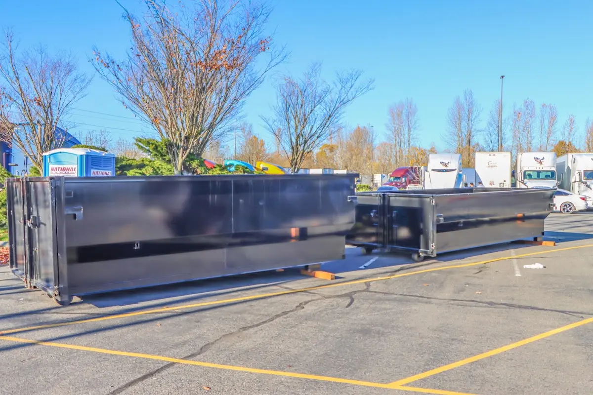 Professional dumpster rental service with roll-off container on residential driveway in Tanque Verde